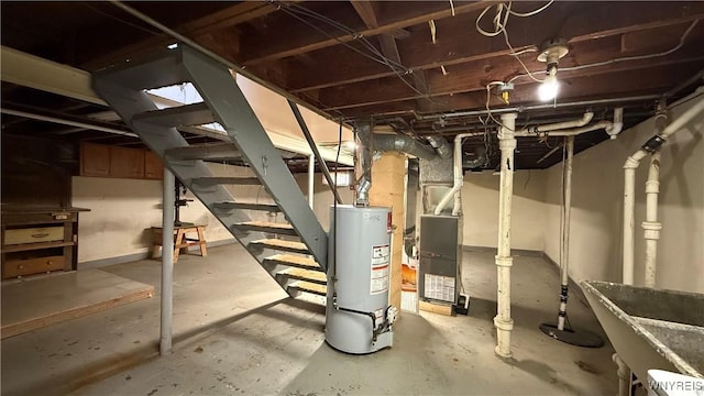unfinished below grade area featuring water heater