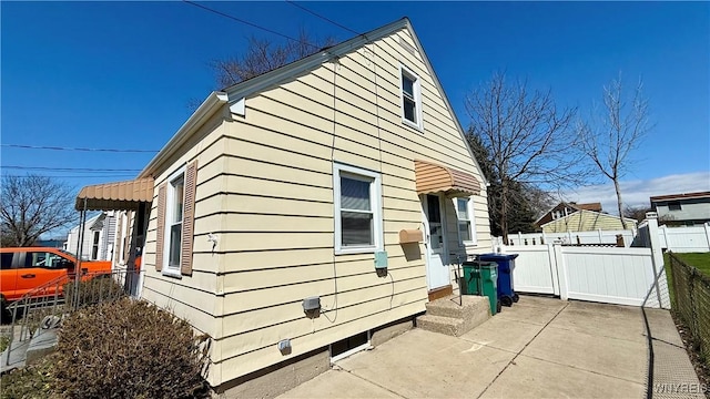 view of side of home with fence and a patio area