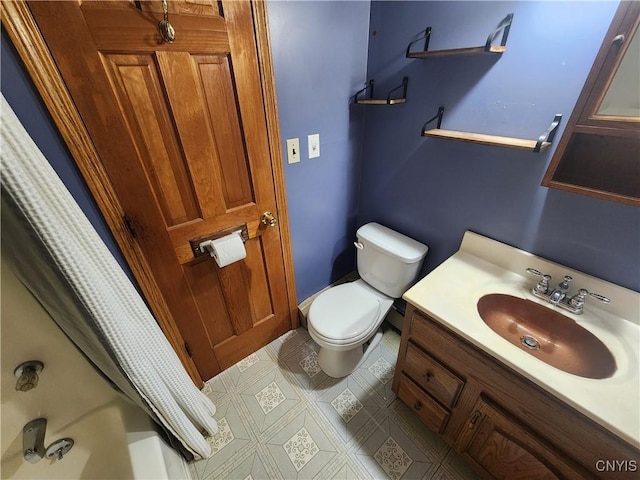 bathroom with shower / bath combo, vanity, and toilet