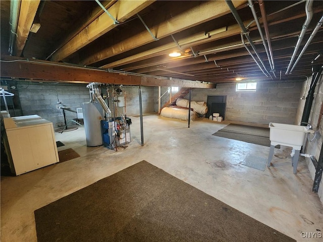 below grade area with washer / dryer, water heater, stairs, and a heating unit