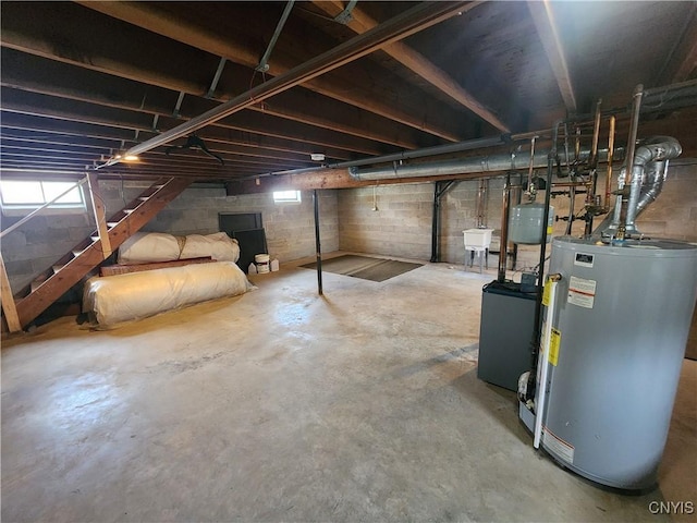 basement featuring water heater and stairway