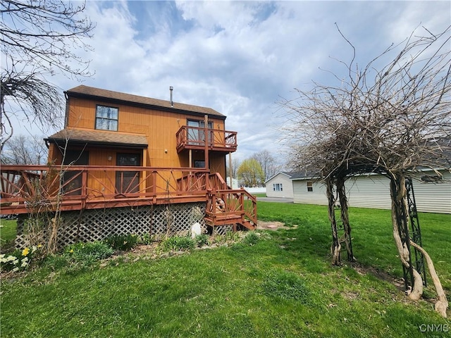 back of house with a deck, a yard, a shingled roof, and a balcony