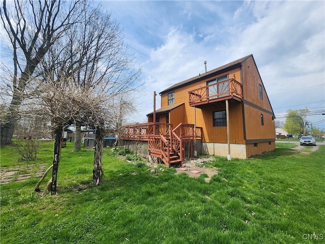 back of property featuring a lawn, a deck, a balcony, and crawl space