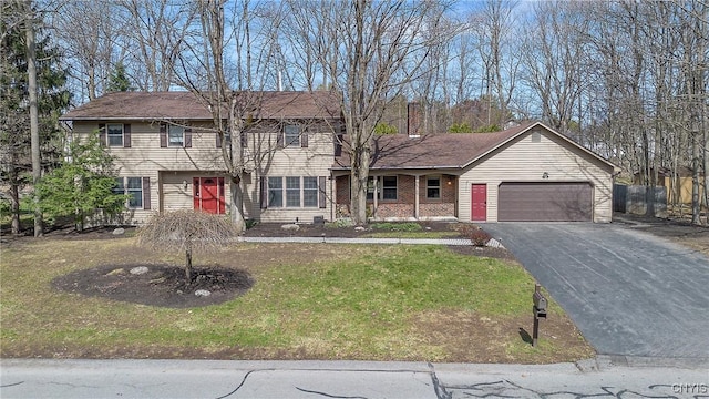 7266 Wakefield Dr, Manlius, NY 13066 - traditional home with a front lawn, fence, a garage, and aphalt driveway