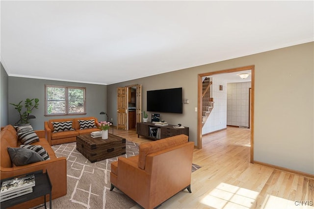 7266 Wakefield Dr, Manlius, NY 13066 - living area featuring ornamental molding, baseboards, light wood-style flooring, and stairs