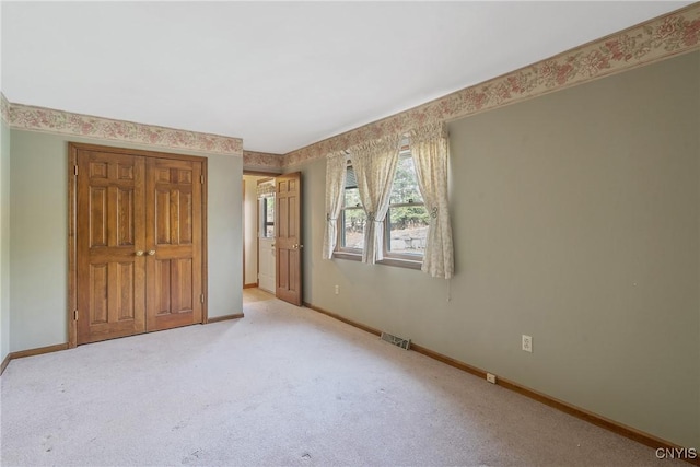 7266 Wakefield Dr, Manlius, NY 13066 - unfurnished bedroom featuring visible vents, light carpet, and baseboards