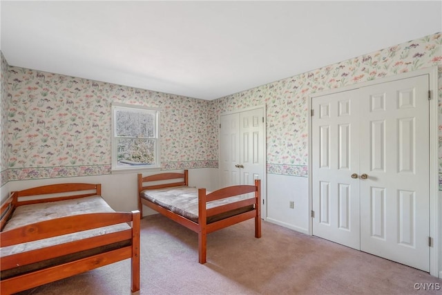 7266 Wakefield Dr, Manlius, NY 13066 - carpeted bedroom featuring wallpapered walls and two closets