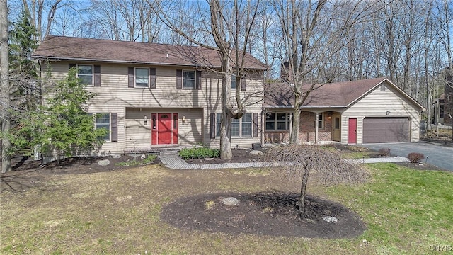 7266 Wakefield Dr, Manlius, NY 13066 - view of front of house featuring a garage, aphalt driveway, a front lawn, and covered porch