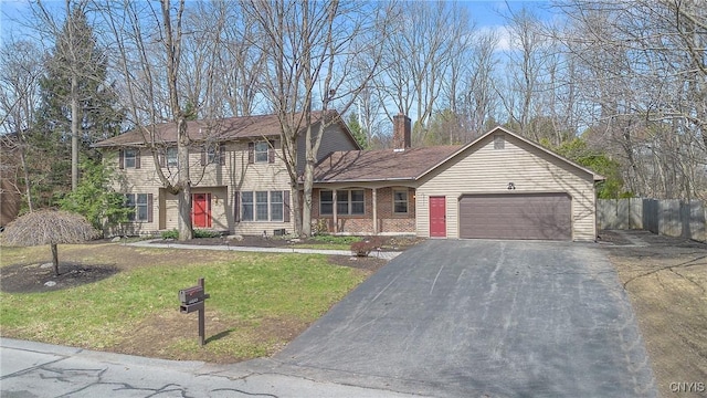 7266 Wakefield Dr, Manlius, NY 13066 - view of front of property featuring a front lawn, driveway, a chimney, an attached garage, and fence