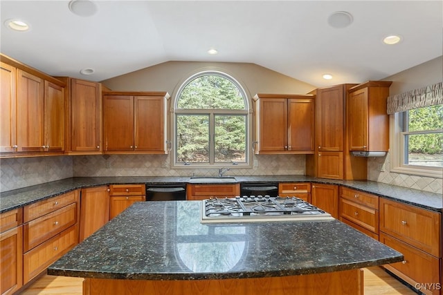 7266 Wakefield Dr, Manlius, NY 13066 - kitchen with a sink, stainless steel gas stovetop, a kitchen island, vaulted ceiling, and black dishwasher