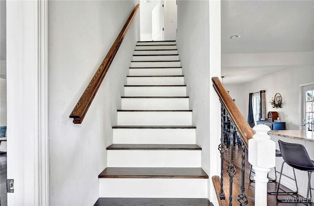 staircase with wood finished floors