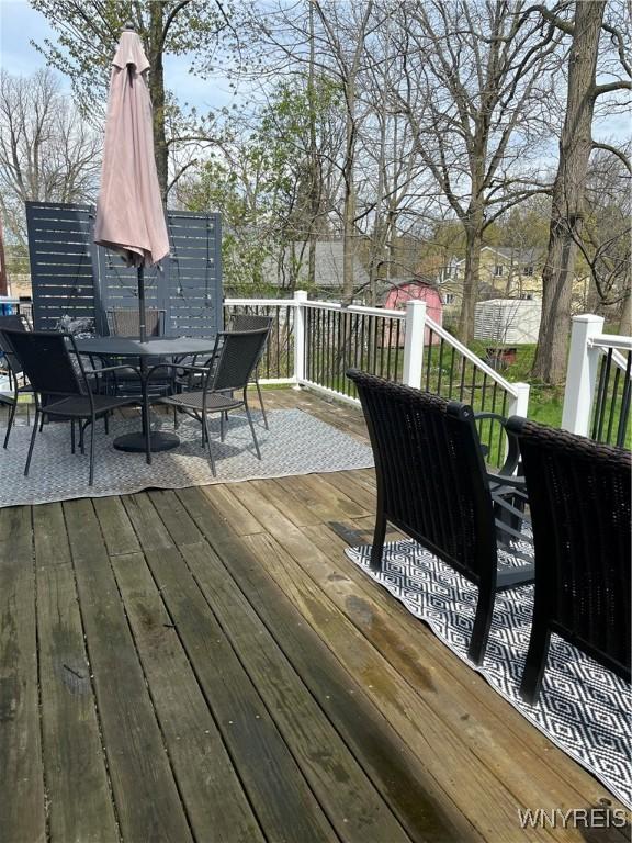wooden deck with outdoor dining area