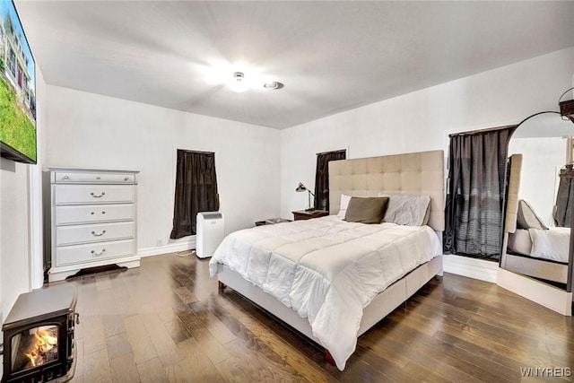 bedroom with baseboards and dark wood-style floors