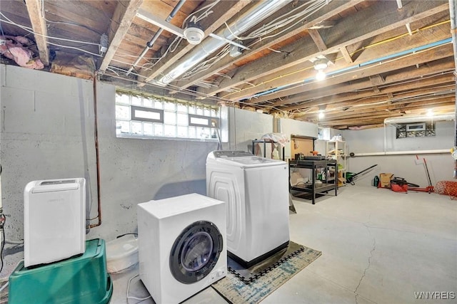 clothes washing area with laundry area and washing machine and clothes dryer