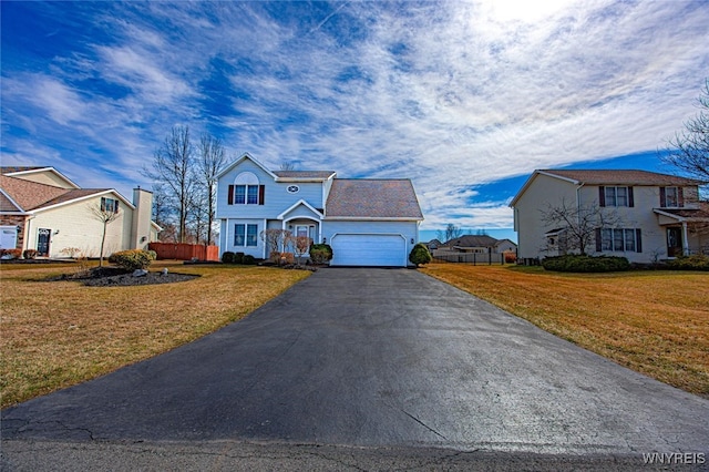 traditional home with aphalt driveway, a residential view, a front lawn, and a garage