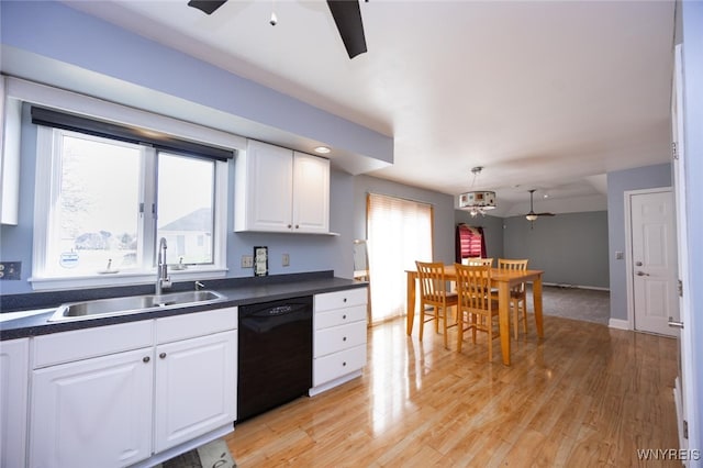 kitchen with a ceiling fan, dark countertops, dishwasher, and a sink