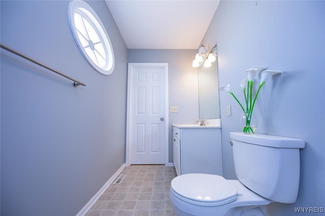 bathroom with baseboards, visible vents, toilet, and vanity