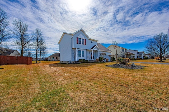 view of front of property with fence and a front lawn