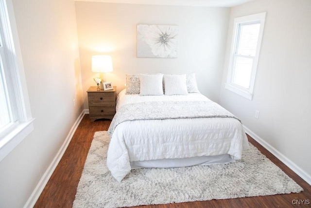 bedroom with baseboards and wood finished floors