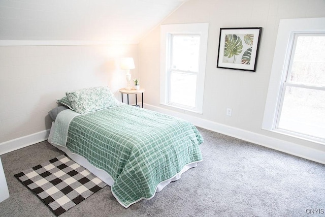 carpeted bedroom with lofted ceiling and baseboards