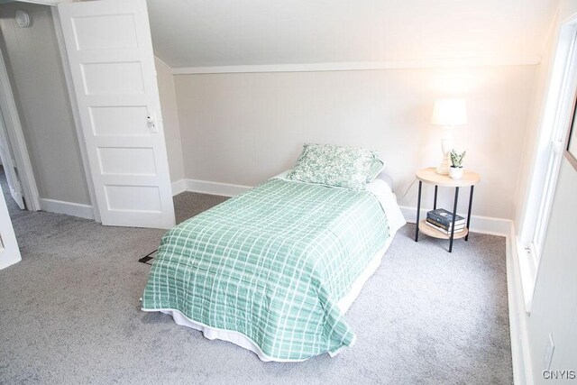 bedroom featuring baseboards, ornamental molding, and carpet flooring