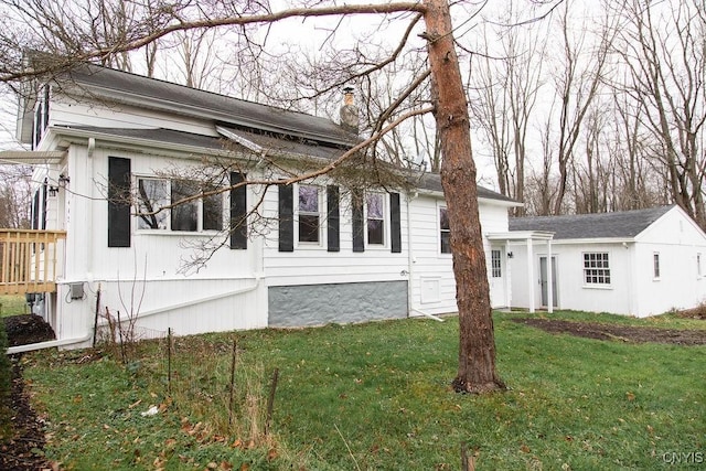 view of front of home with a chimney and a front yard