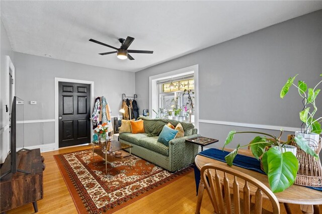 living room featuring a ceiling fan and wood finished floors