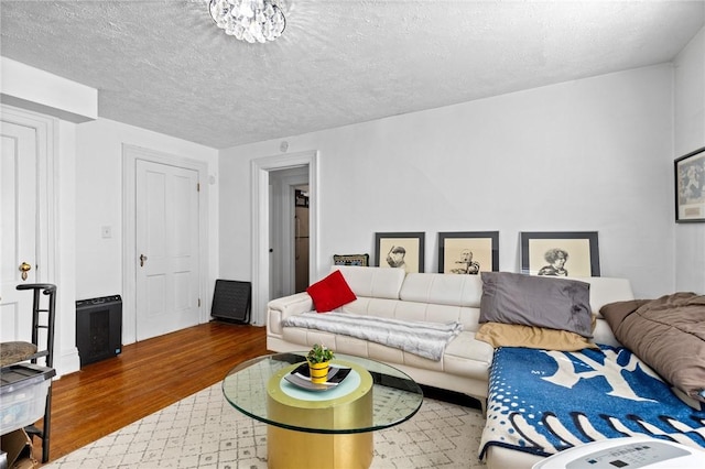 living area with a textured ceiling and wood finished floors