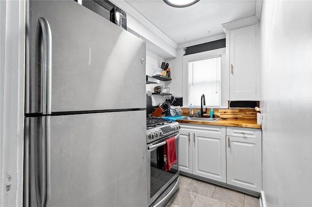 kitchen featuring ornamental molding, a sink, white cabinets, and stainless steel appliances
