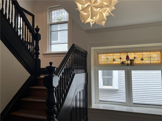 stairs featuring a chandelier and plenty of natural light