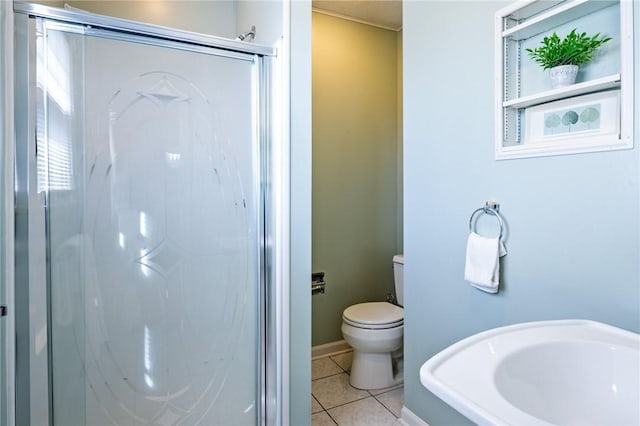 bathroom featuring toilet, a shower stall, and tile patterned flooring