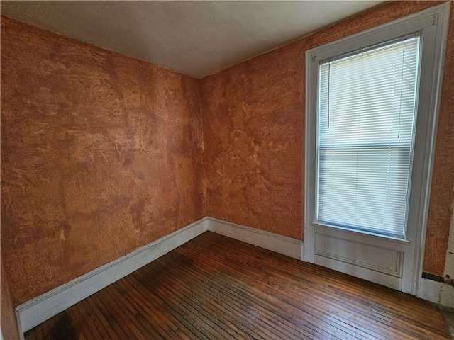 unfurnished room featuring dark wood finished floors and baseboards