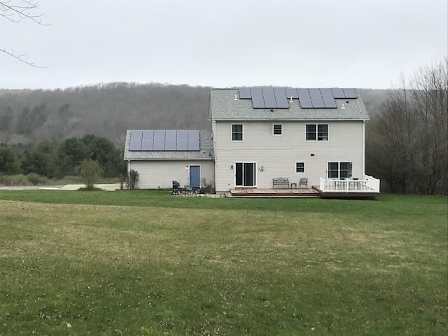 5876 Clearview Ln, Alfred, NY 14803 - back of property with a lawn, a wooden deck, and solar panels
