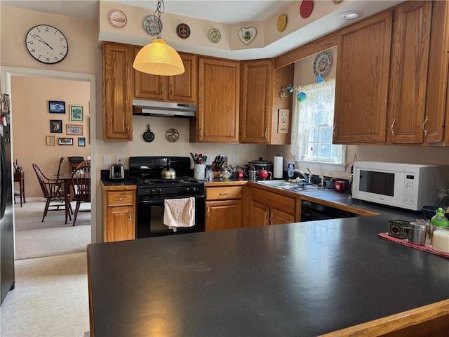 5876 Clearview Ln, Alfred, NY 14803 - kitchen with under cabinet range hood, dark countertops, black gas stove, and white microwave