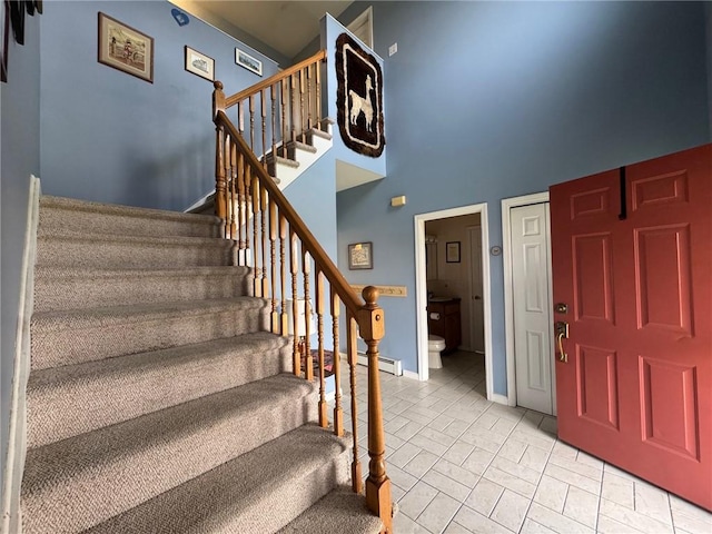 5876 Clearview Ln, Alfred, NY 14803 - foyer with a high ceiling, baseboards, a baseboard heating unit, and stairs