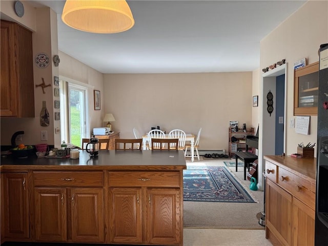 5876 Clearview Ln, Alfred, NY 14803 - kitchen featuring a baseboard heating unit, dark countertops, brown cabinets, and a peninsula