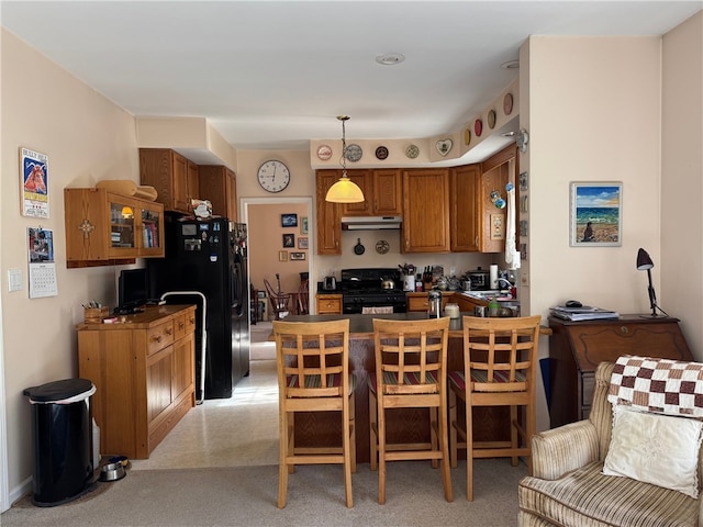 5876 Clearview Ln, Alfred, NY 14803 - kitchen featuring light colored carpet, brown cabinets, black appliances, pendant lighting, and a peninsula