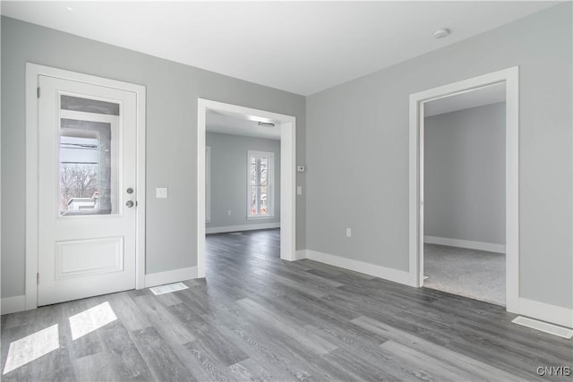 entryway with wood finished floors and baseboards
