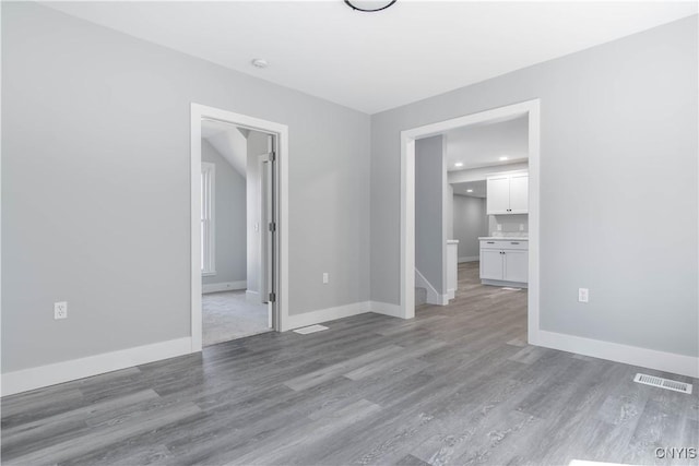 unfurnished bedroom with baseboards, visible vents, light wood-style floors, and recessed lighting