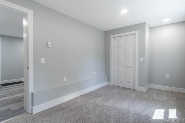 unfurnished bedroom with baseboards, recessed lighting, and carpet flooring