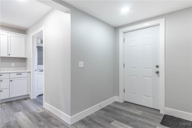 entryway featuring light wood-style flooring and baseboards