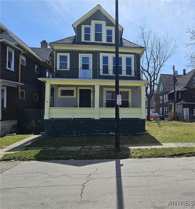 american foursquare style home featuring a balcony