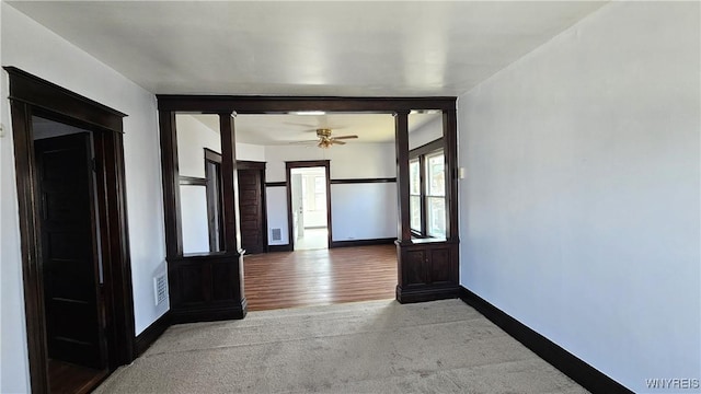 hall with baseboards, visible vents, and carpet