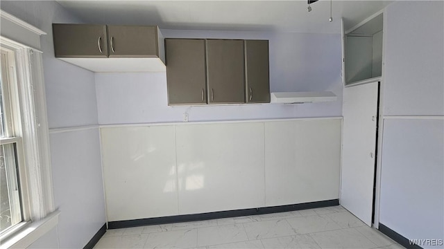 unfurnished room featuring marble finish floor