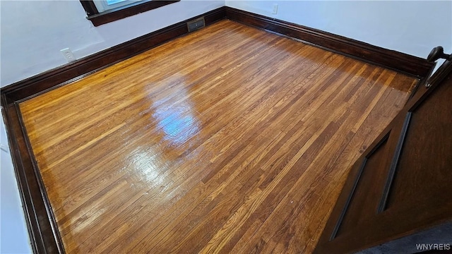 interior details featuring wood finished floors and baseboards