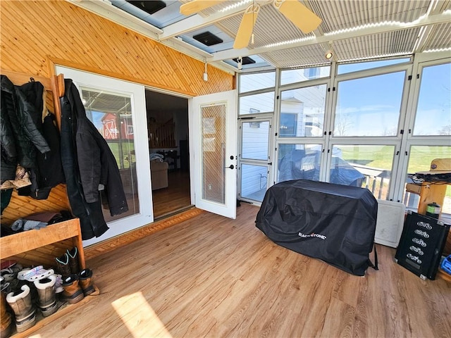 sunroom featuring ceiling fan and french doors