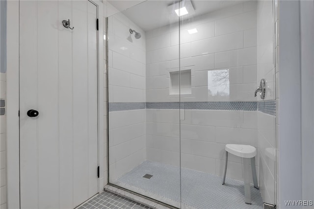 bathroom with tile patterned floors and a stall shower