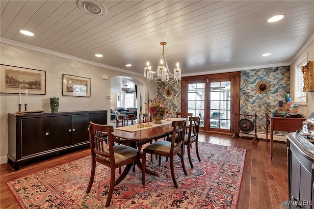 dining area featuring crown molding, arched walkways, and a wealth of natural light