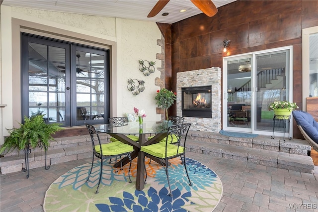 4482 Lower River Rd, Lewiston, NY 14092 - view of patio with outdoor dining space, ceiling fan, french doors, and a fireplace
