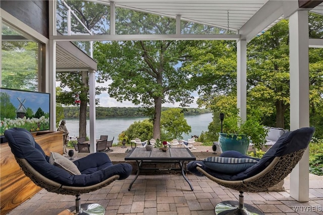 4482 Lower River Rd, Lewiston, NY 14092 - sunroom / solarium featuring a water view, floor to ceiling windows, brick flooring, and healthy amount of natural light